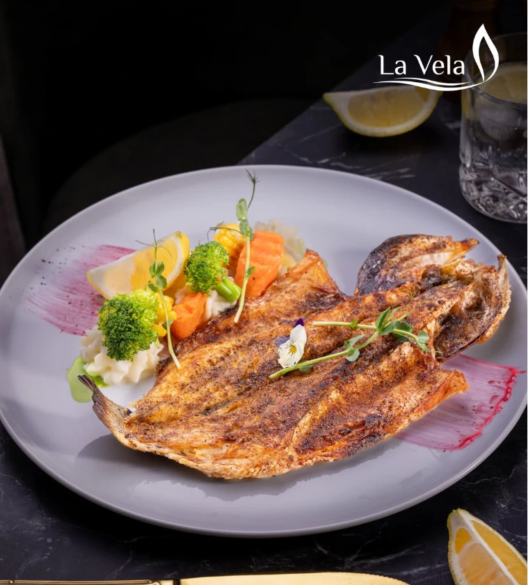 Grilled whole fish with seasonal vegetables